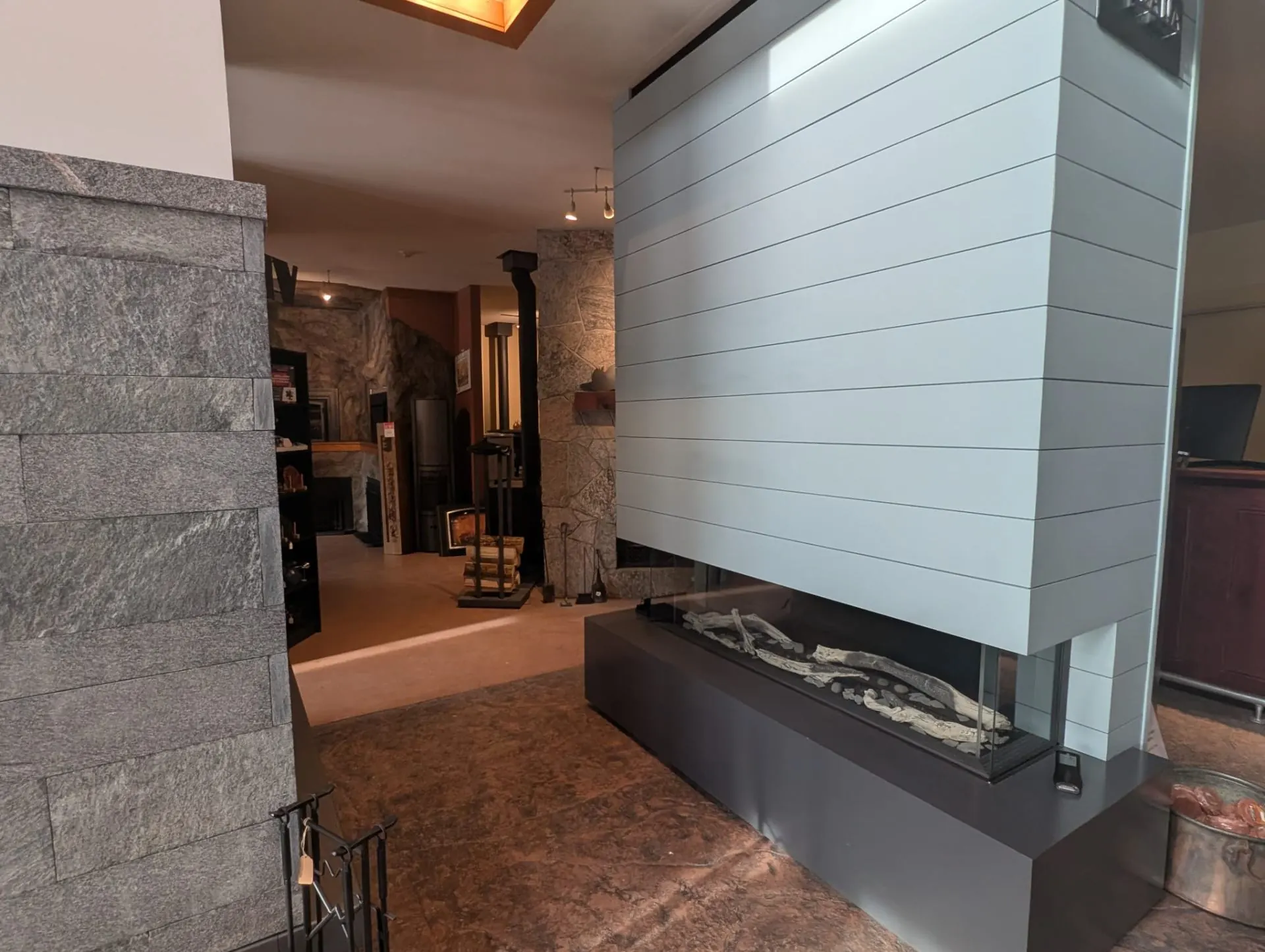 Modern white linear gas fireplace on display