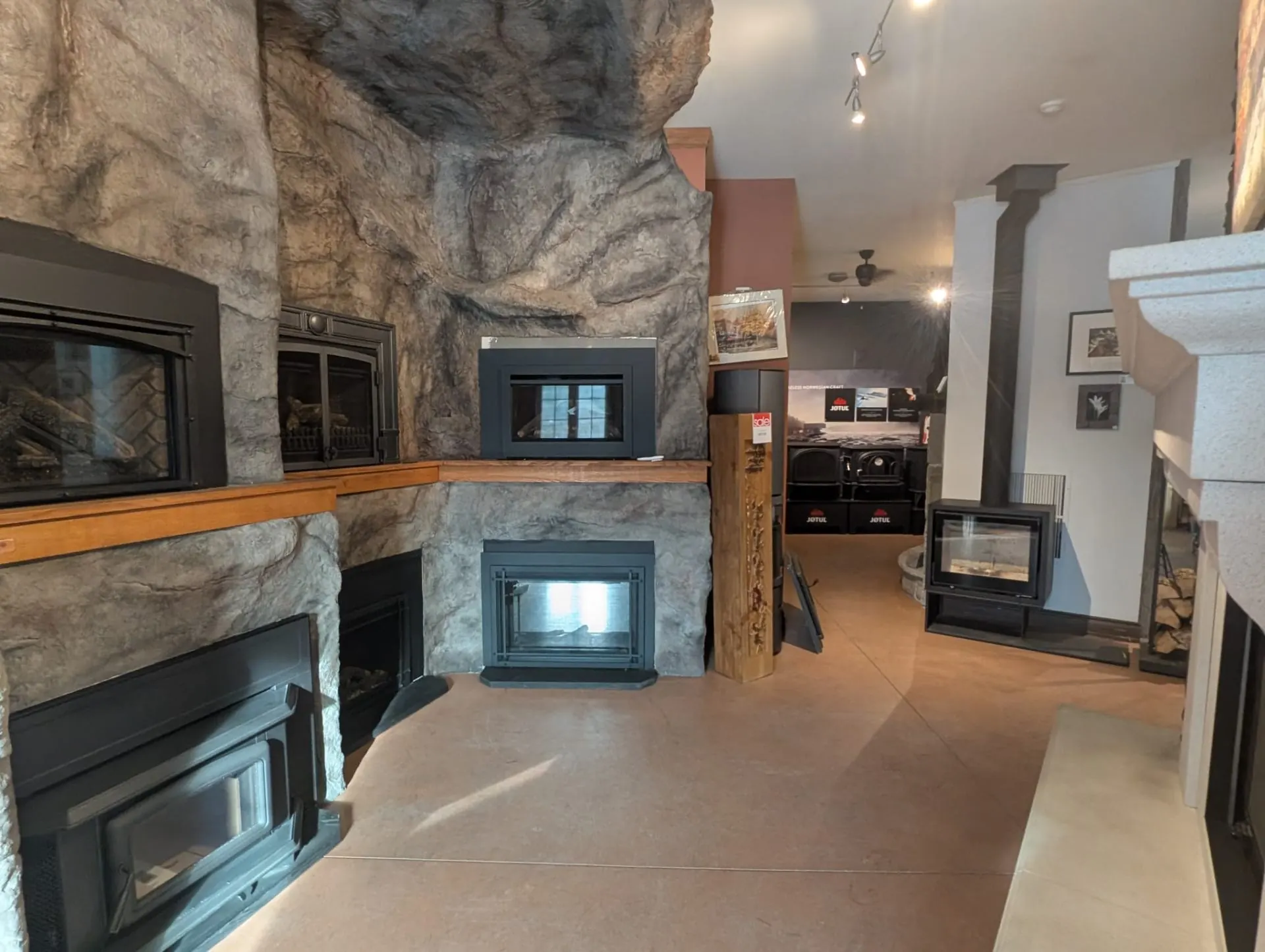 Stone cave wall with fireplace inserts on display