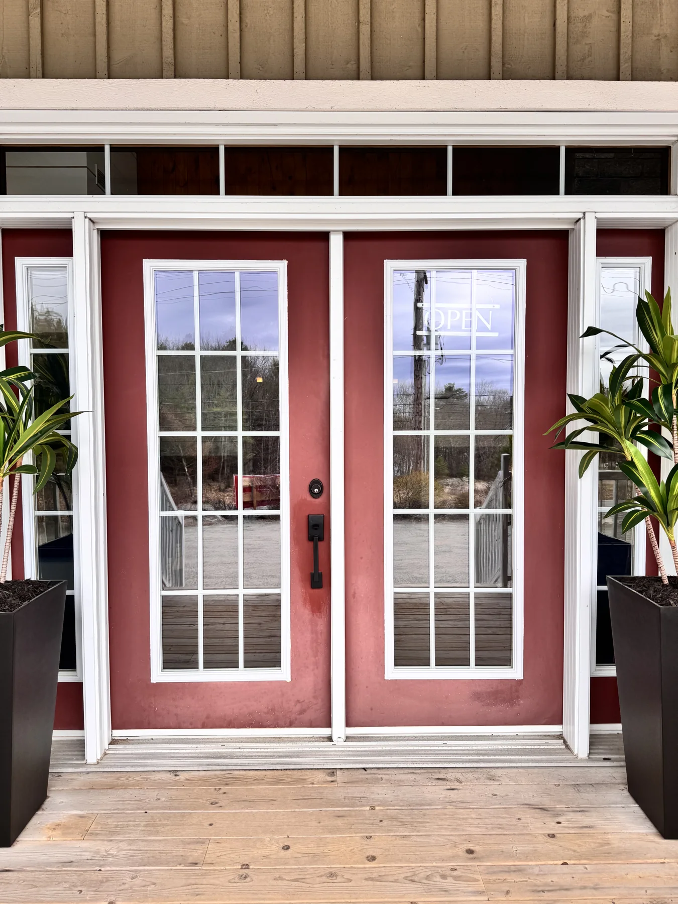 The red double front doors of The Fireplace Stop North