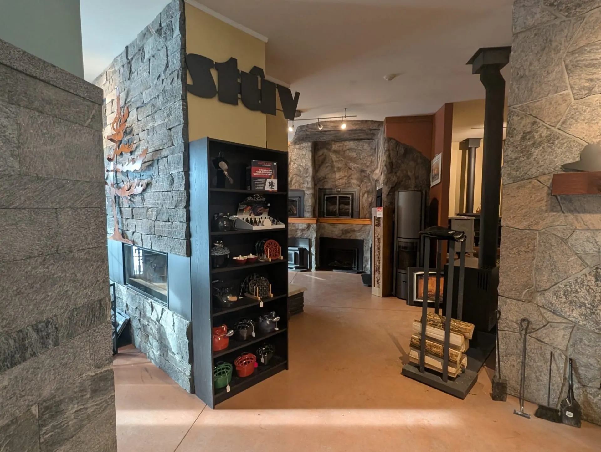 Stûv branded stone fireplace display on the Fireplace Stop North showroom floor